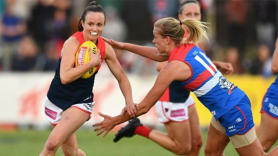 AFL Women's player Daisy Pearce, for the Melbourne Demons, breaks away from an opponent