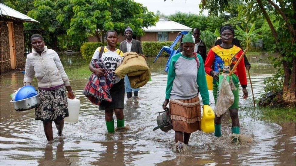 Displaced families flee to higher ground in Kakola village in Nyando sub-county in Kisumu after their houses were flooded on 3 December 2019