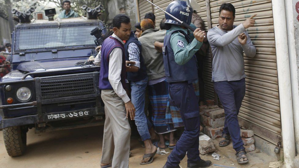 Police try to control crowds that have gathered near an area where suspected Islamist militants are hiding in Dhaka, Bangladesh, 24 December 2016