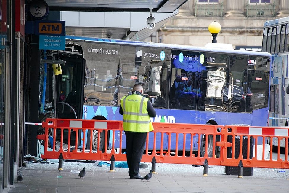 Emergency services at the scene of a bus crash in Manchester's Piccadilly Gardens