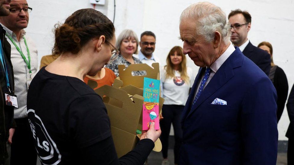 King Charles with volunteers at the food bank