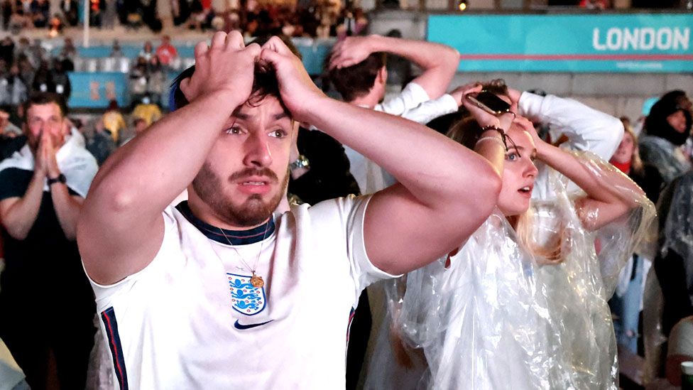 England fans react after Italy won the Euro 2020 at Trafalgar Square