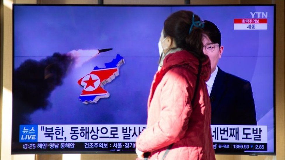 A woman watchs the news at a station in Seoul, South Korea, 17 January 2022.