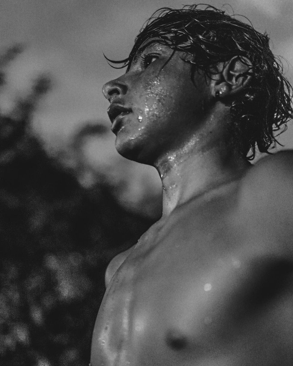 Black and white photo of a teenage boy with wet hair