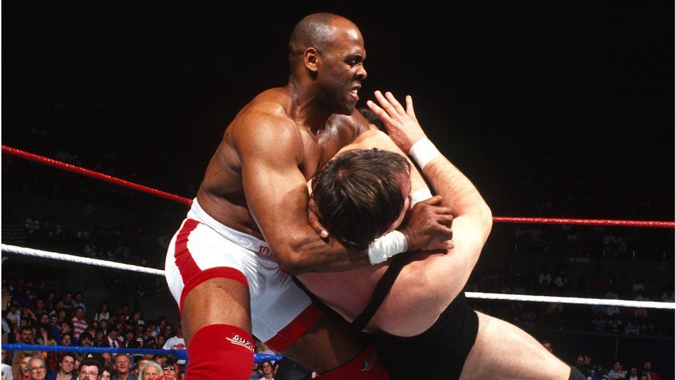 Michael "Virgil" Jones with another wrestler in a headlock