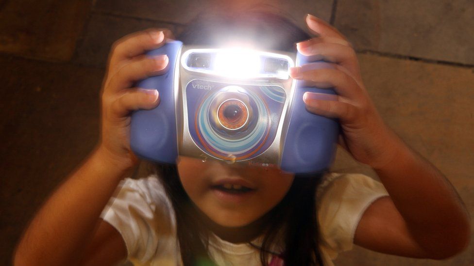 child holding vtech camera
