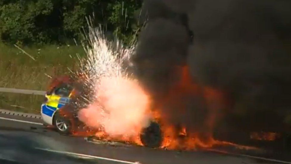 Moment a Devon and Cornwall police car, already on fire, explodes