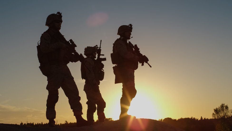 The silhouette of three soldiers