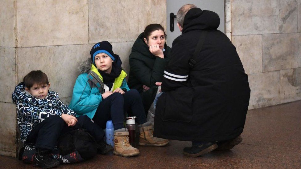 A family takes shelter in a metro station in Kyiv in the morning of February 24, 2022