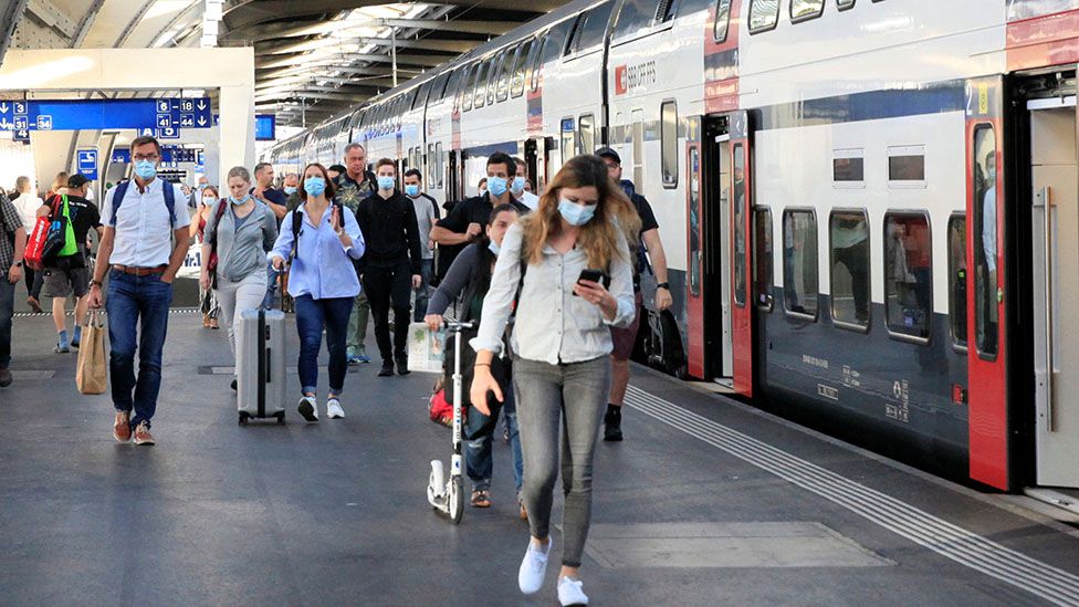 Passengers wear protective masks as they leave a train of Swiss railway operator SBB, as the coronavirus disease (COVID-19) outbreak continues, at the Hauptbahnhof central station in Zurich, Switzerland July 6, 2020.