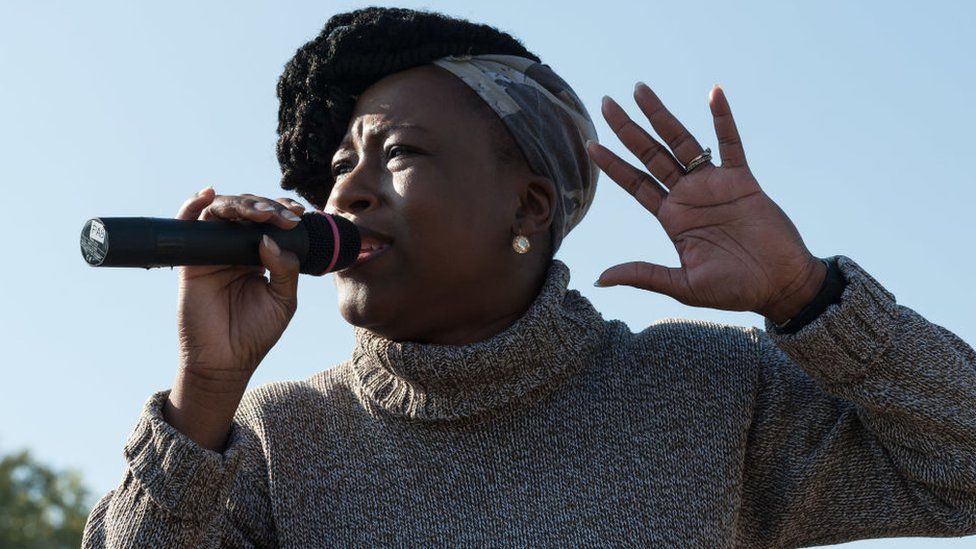 Dr Shola Mos-Shogbamimu addresses a rally in London