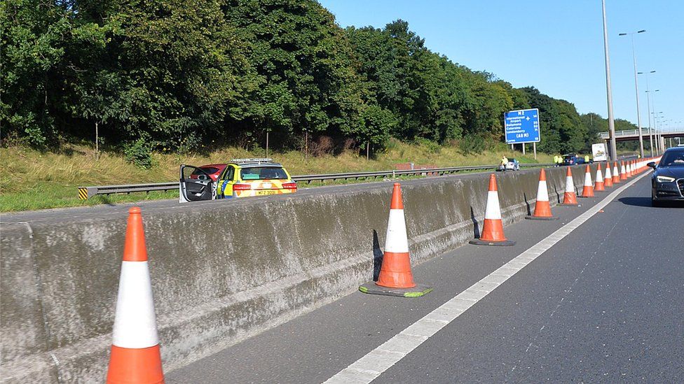 Woman dies after collision with bus on M2 - BBC News