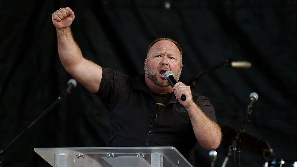 Alex Jones speaks to Trump supporters at a rally in December 2020