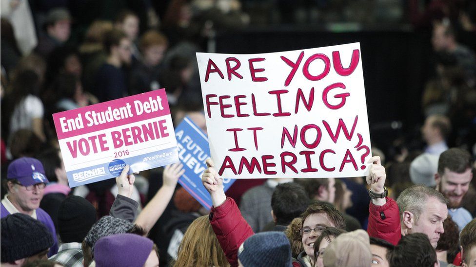 Supporters of U.S. Senator and Democratic Presidential Candidate Bernie Sanders hold signs at Sanders' first campaign rally in Michigan at Eastern Michigan University February 15th, 2016 in Ypsilanti, Michigan