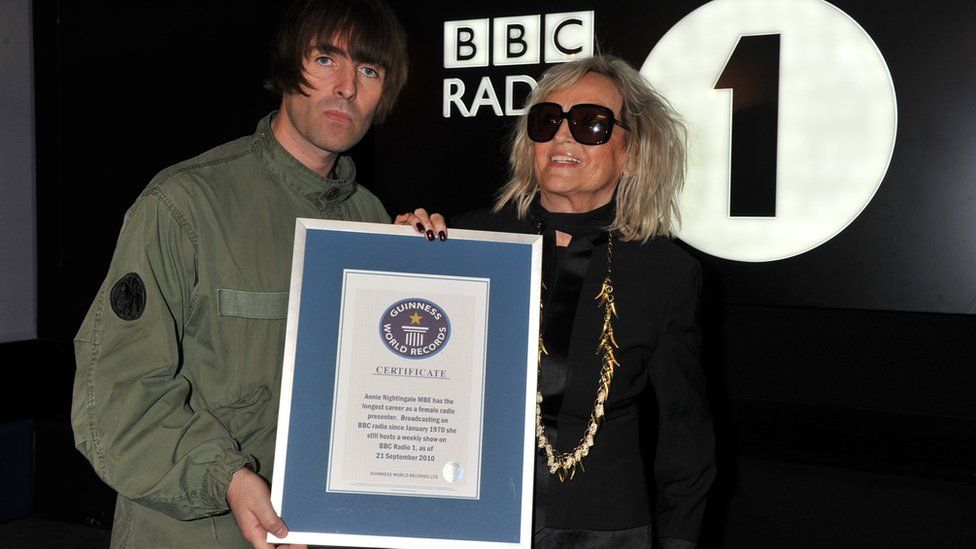 Liam Gallagher presenting Annie Nightingale with certificate