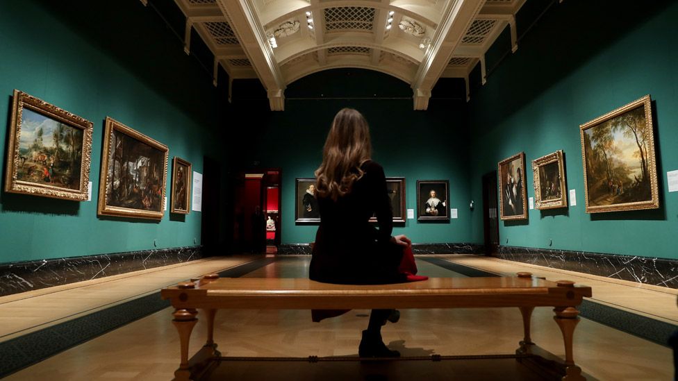 A woman looks at paintings during the Masterpieces exhibition photocall at The Queen's Gallery, Buckingham Palace on December 03, 2020
