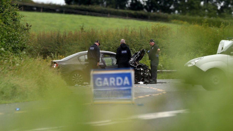 Garda (Irish police) examine one of the three vehicles involved in the fatal crash