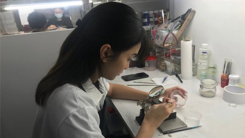 Woman works at medal-maker Royal Insignia