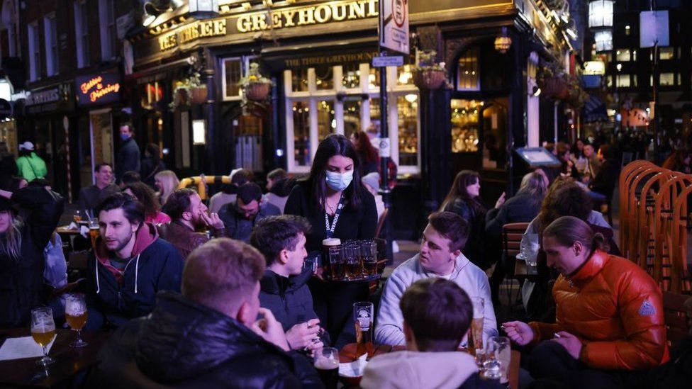 Drinkers enjoy pints at a pub in London