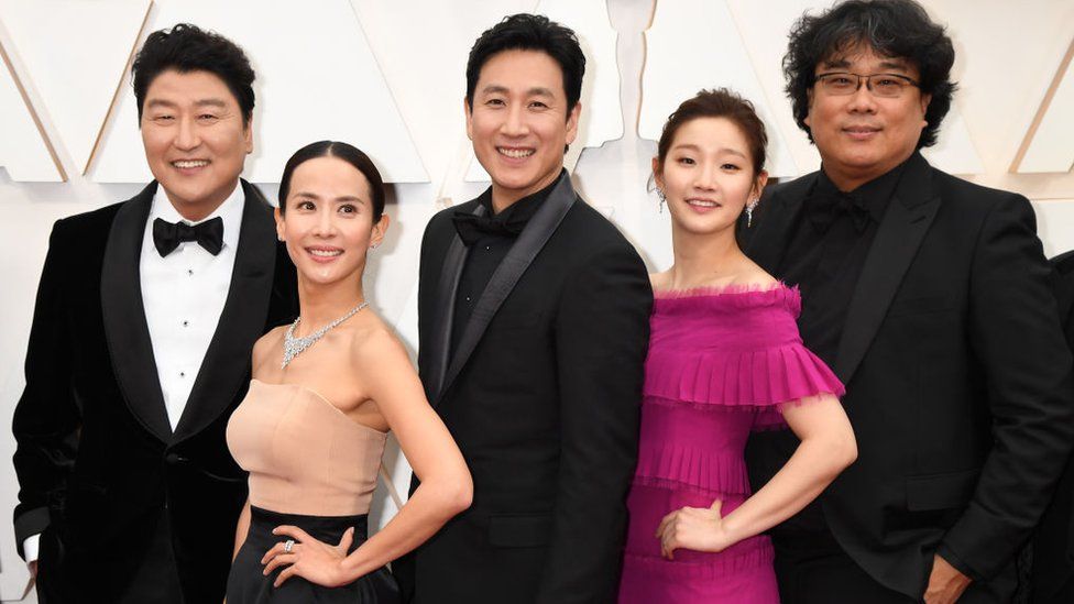 Director Bong Joon-ho (R) with cast and crew of "Parasite" attend the 92nd Annual Academy Awards at Hollywood and Highland on February 09, 2020 in Hollywood, California.