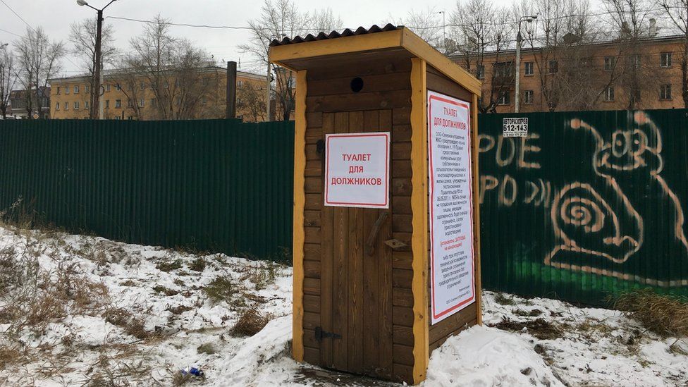 "Toilet for debtors" reads a notice on the outside loo in Irkutsk