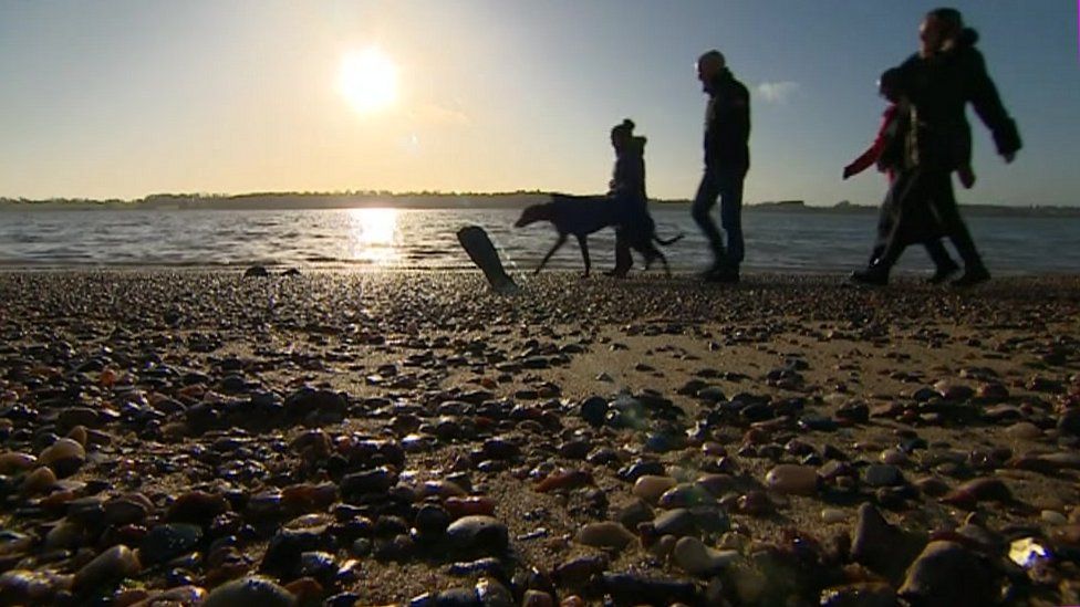 The Barnes family walking on the shore of the Orwell estuary