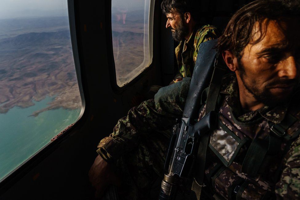 Wounded Afghan soldiers aboard a helicopter north of Kandahar, Afghanistan, 6 May