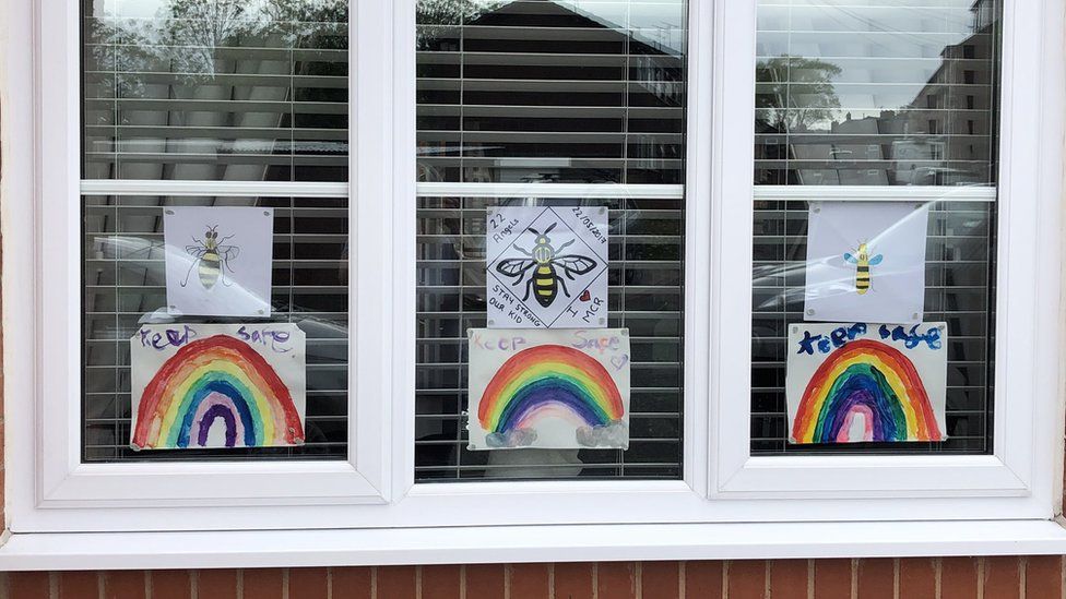 Bees and rainbow pictures in window