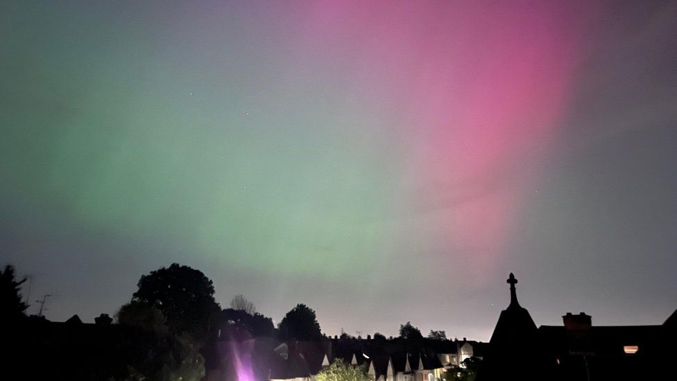 A view of green and red lights over rooftops in Finchley, north London