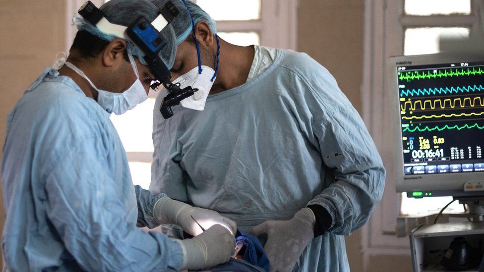 Members of an Indian surgical team perform an endoscopic surgery