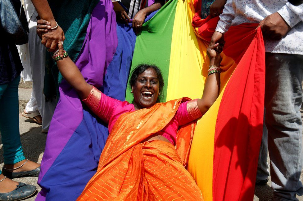 An activist of the LGBT community celebrates after the Supreme Court's verdict
