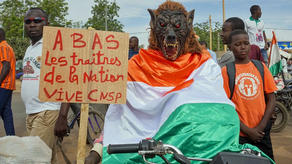 A pro-junta holds up a sign that reads: "Down with traitors of the nation, long live the military council", Niamey, Niger - Saturday 9 December 2023