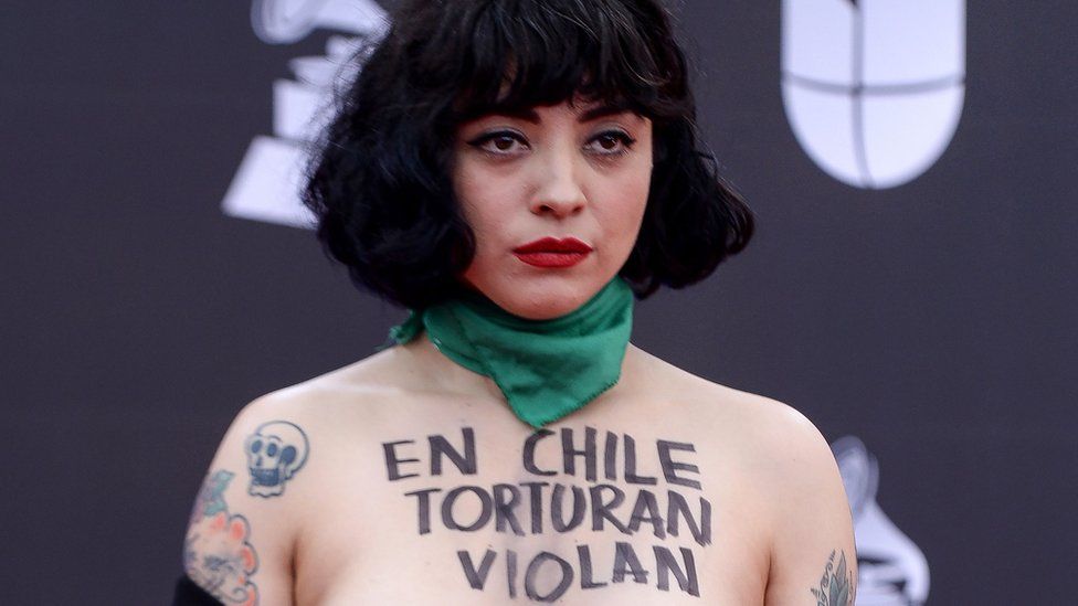 Mon Laferte pictured with the words "in Chile they torture, rape and kill".