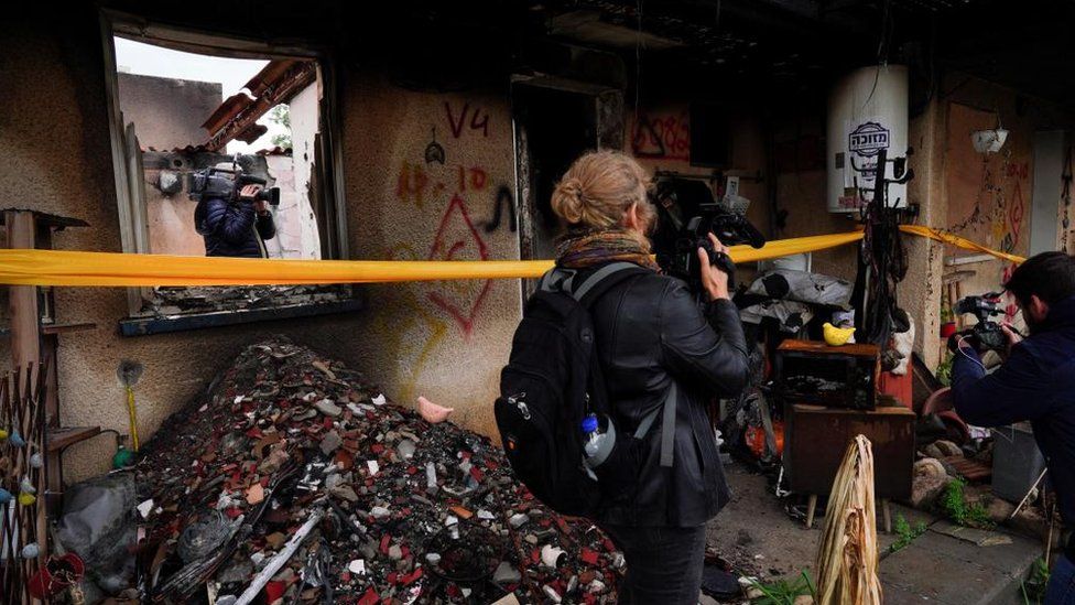 Journalists capture images of the destroyed house of released hostage Amit Soussana, at the Kibbutz Kfar Aza, Israel, on 29 January 2024.