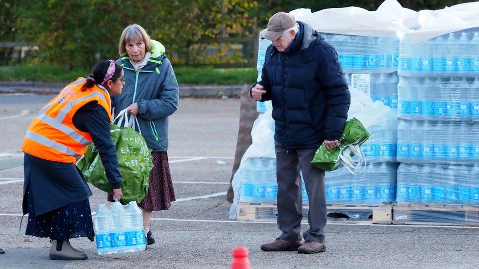 Residents collecting water from a bottled water station