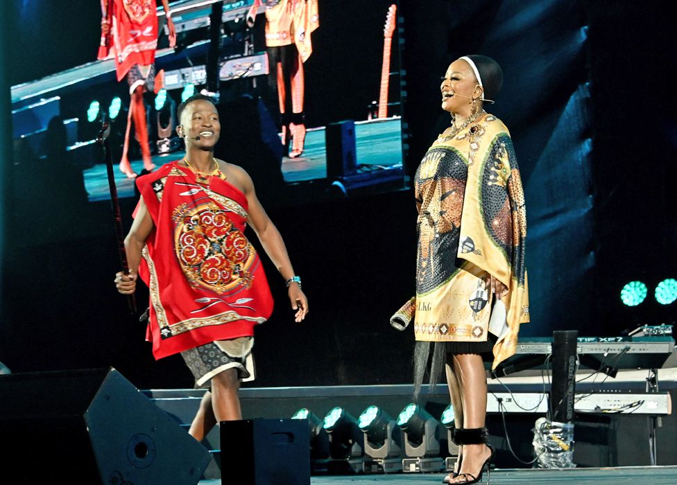 South Africa presenters Katlego Maboe (l) and Lerato Kganyago (r) on stage in traditional outfits at Mbombela Stadium, South Africa - Saturday 6 May 2023
