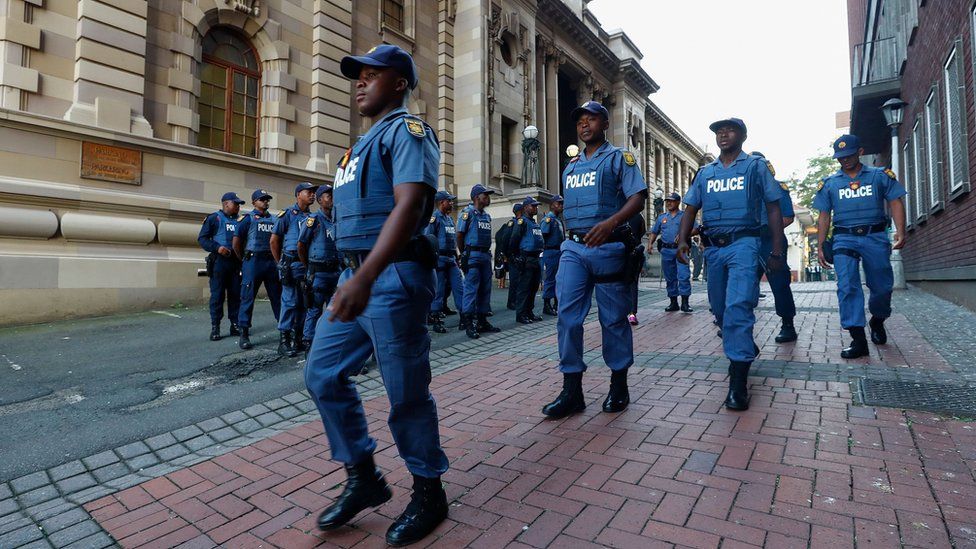 South African police muster outside the KwaZulu-Natal High Court in Durban on 6 April 2018