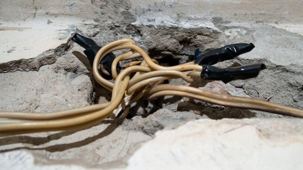 Electrical wires sticking out of a wall