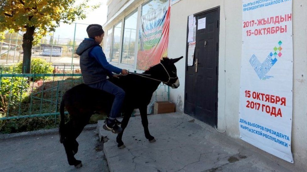 A young man rides on adonkey near a polling station in the village of Kyzyl-Berlik, Kyrgyzstan. Photo: 12 October 2017