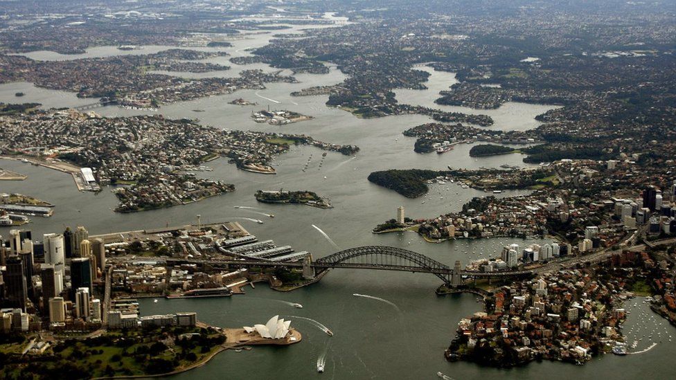Aerial view of Sydney with bridge prominent in foreground