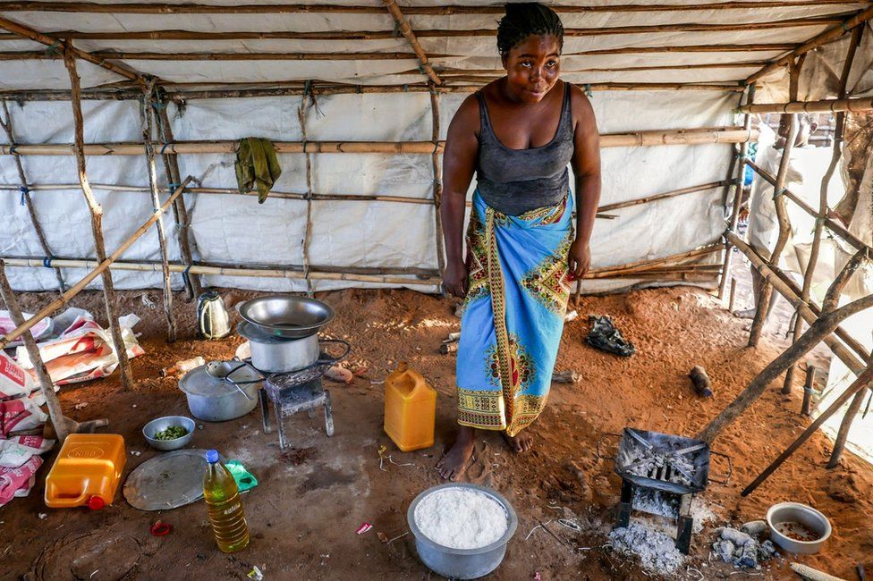 A woman prepares a meal with rice, aid from Caritas Mozambique, for a family with 30 displaced people, in Pemba, Mozambique, 30 March 2021 (issued on 01 April 2021).