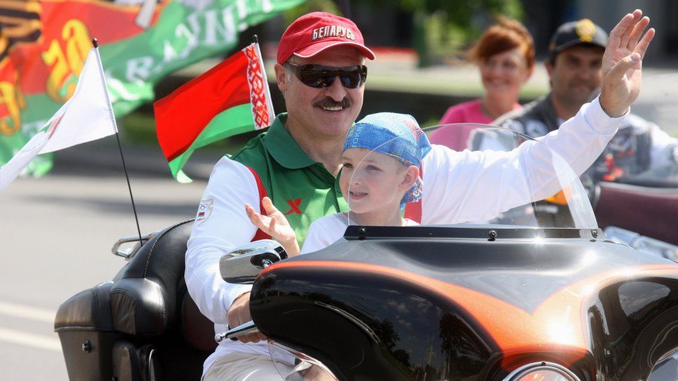 Alexander Lukashenko riding a Harley-Davidson motorcycle with his son Nikolai in his lap, in Minsk, 2009