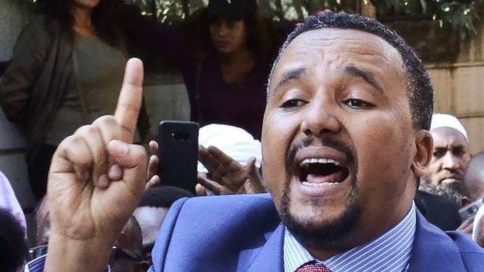 Jawar Mohammed (C), a member of the Oromo ethnic group who has been a public critic of Abiy, addresses supporters that had gathered outside his home in the Ethiopian capital, Addis Ababa after he accused security forces of trying to orchestrate an attack against him October 24, 2019