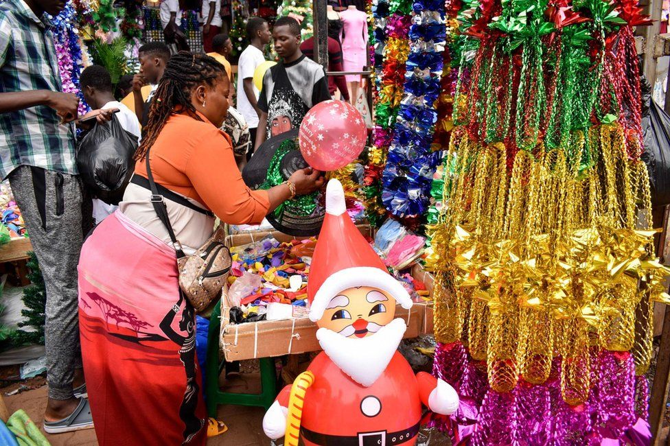 A seller displays Christmas decorations for sale at Kikuubo lane in Kampala, Uganda, 17 December 2023. Ugandans are buying festival decorations and taking public transportation back to their villages as Christmas is nearing. According to official government figures, an estimated 85 percent of the country is Christian.