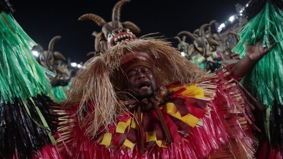 embers of the Grande Rio samba school perform during a carnival parade at the Sambadrome in Rio de Janeiro, Brazil, early 24 April 2022