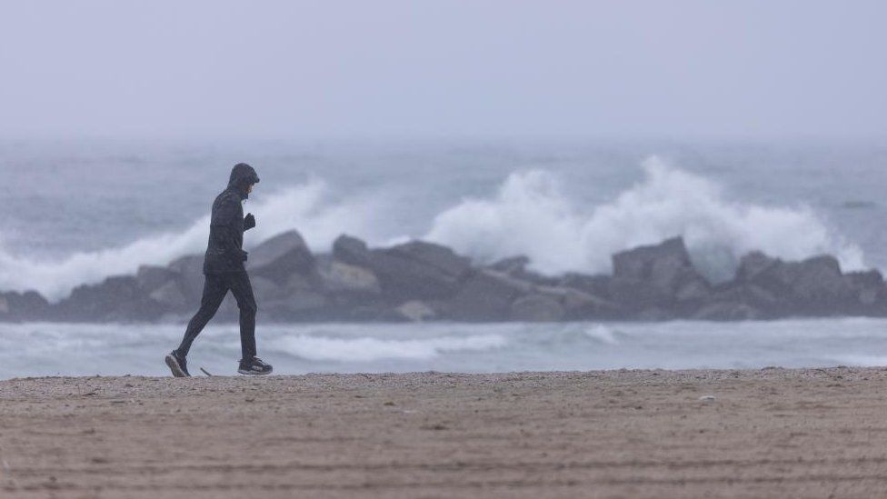 man jogging on beach