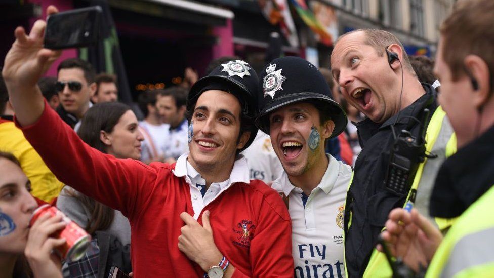 Real Madrid fans take a selfie with a policeman ahead of the Champions League final in Cardiff