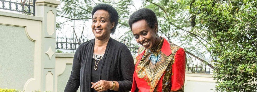 Diane Rwigara (R), a critic of Rwanda's President, and her mother Adeline Rwigara (L) walk in a garden