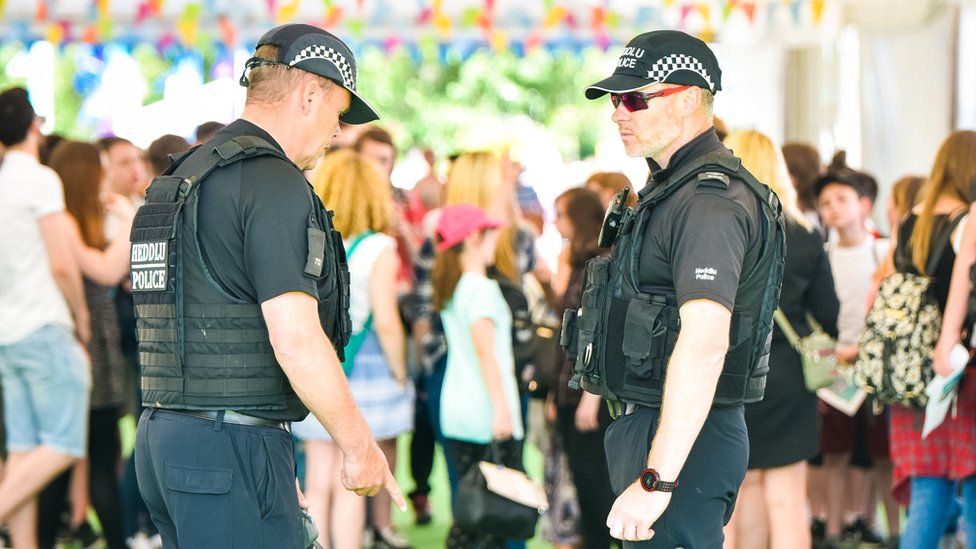 armed police inside festival tent