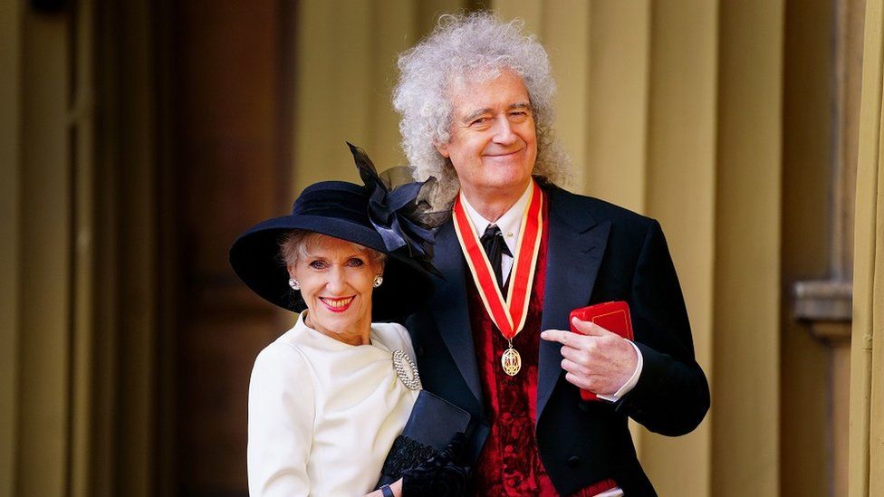 Brian May with wife Anita Dobson after being knighted